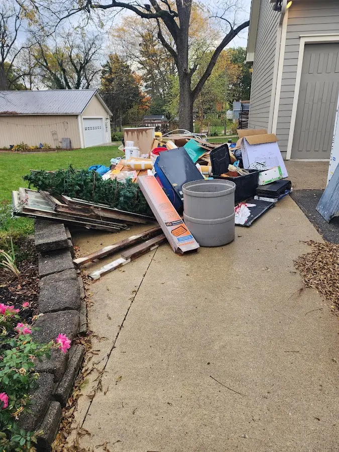 Dumpster being loaded with debris for Estate Cleanout Dumpster Rental in East Palo Alto